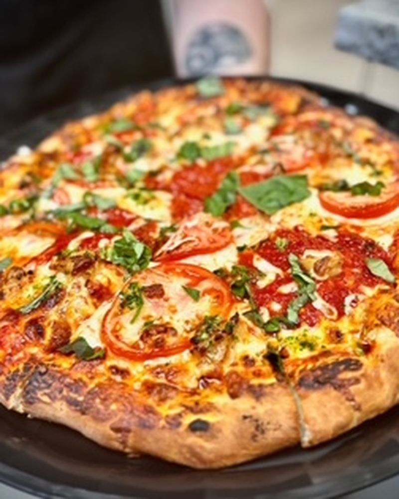 Fresh pizza with tomato and basil