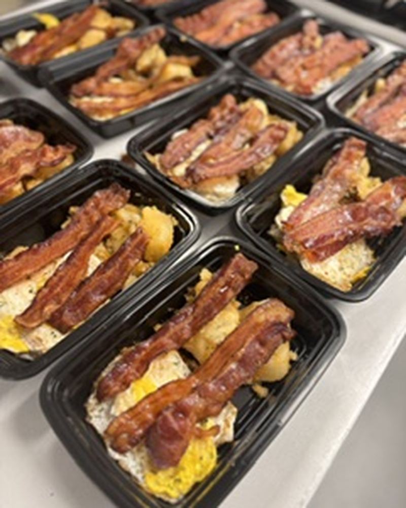 Boxed breakfast meals with bacon and eggs