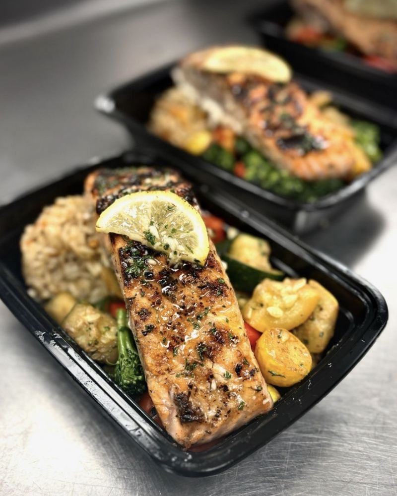 Boxed salmon meals with lemon and vegetables