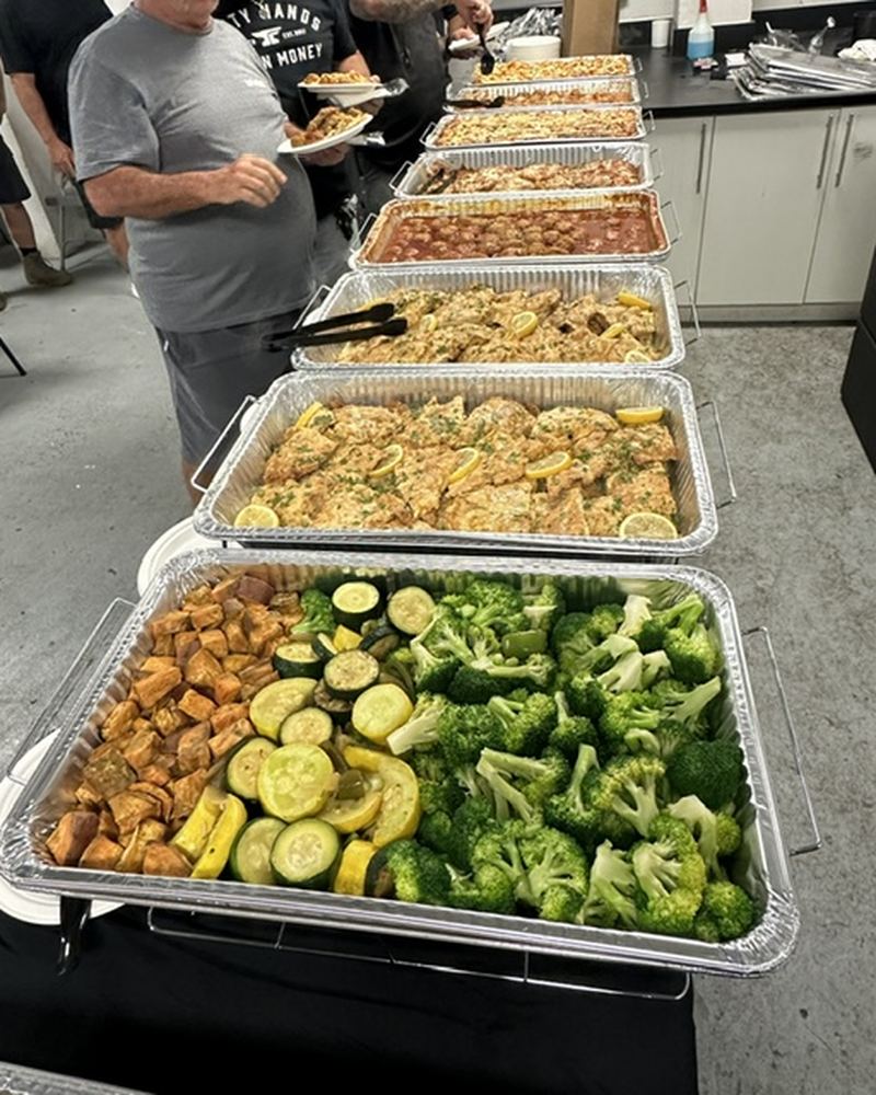 Guests serving themselves from a hot buffet line