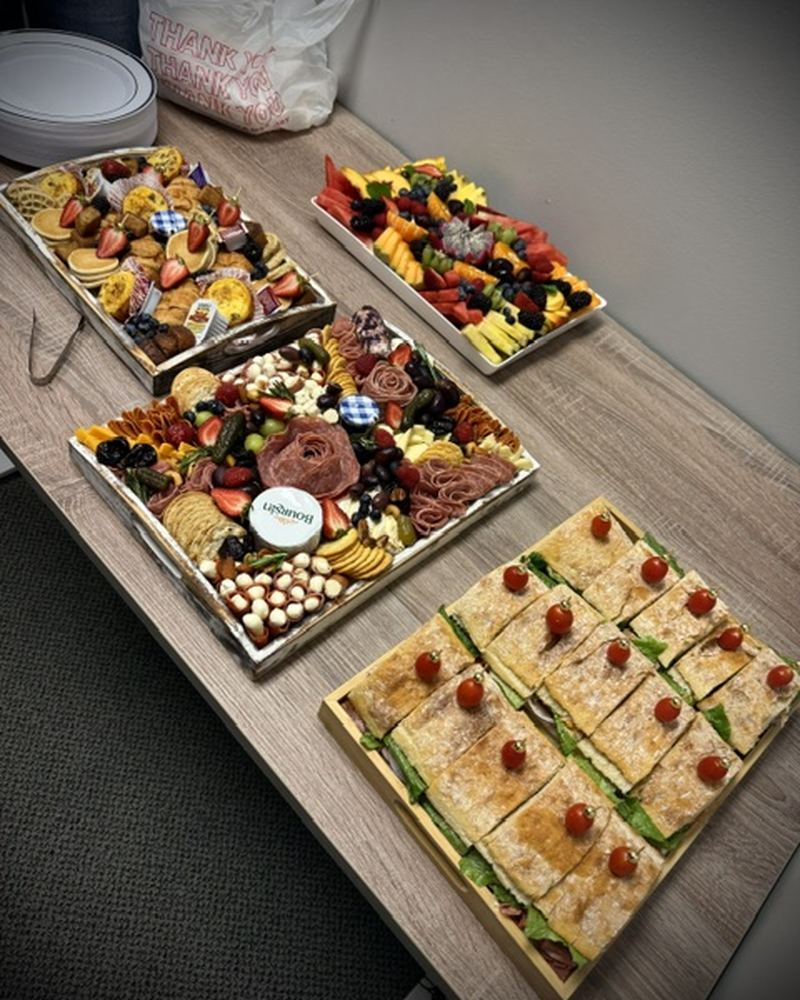 Office catering spread of sandwiches, wraps and platters