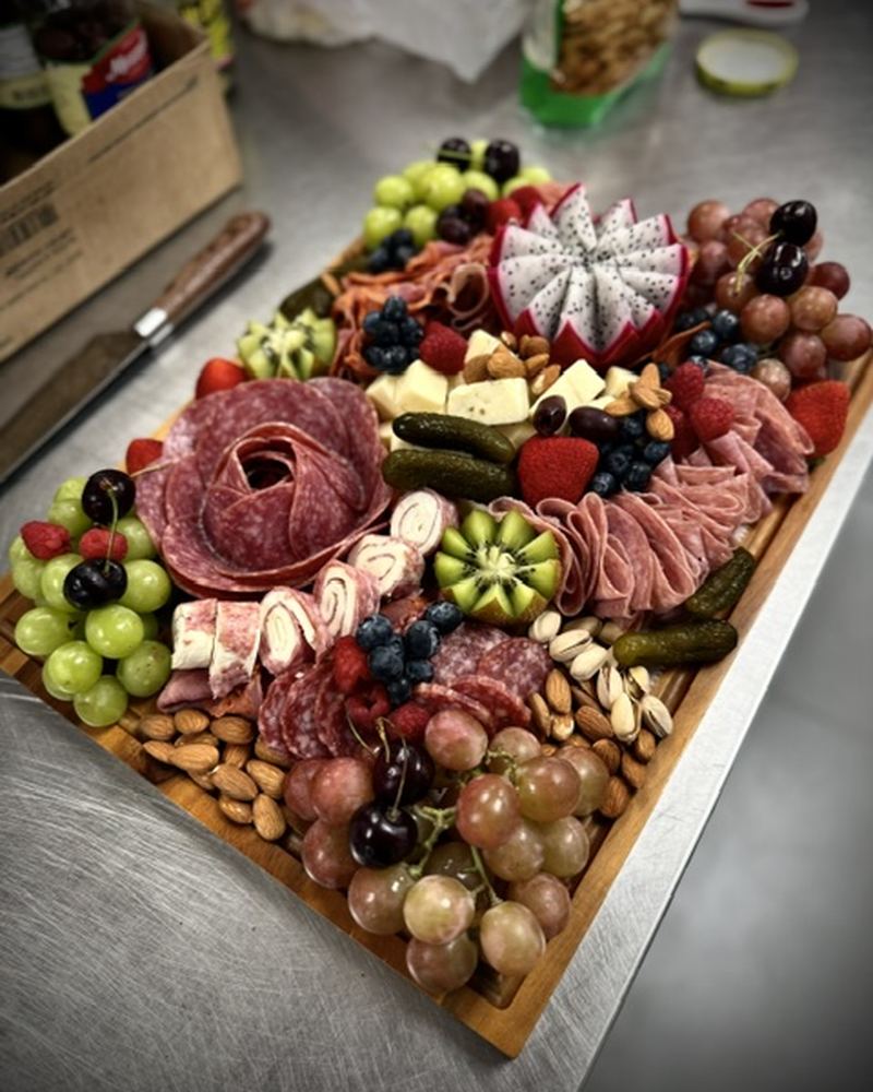 Large grazing board with meats, cheeses, nuts and fruit
