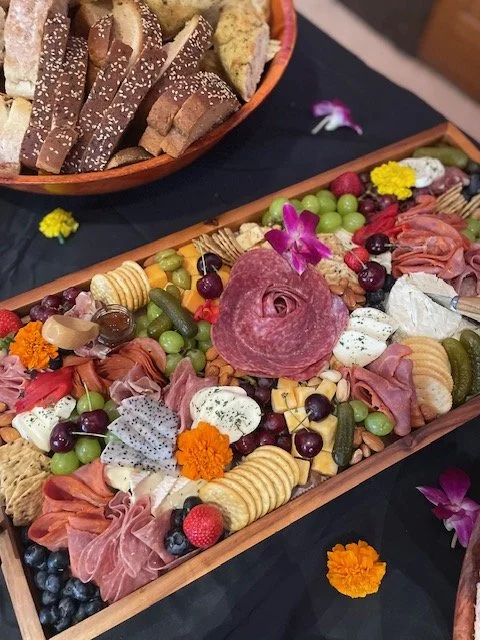 Catered charcuterie with fresh fruit, cheese, and bread