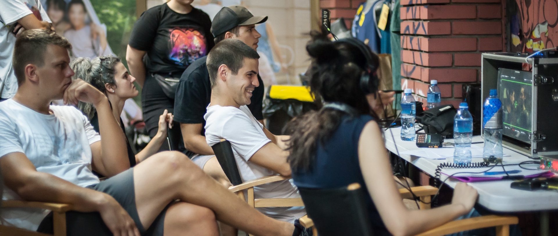 Film crew watching a director's monitor on a production set